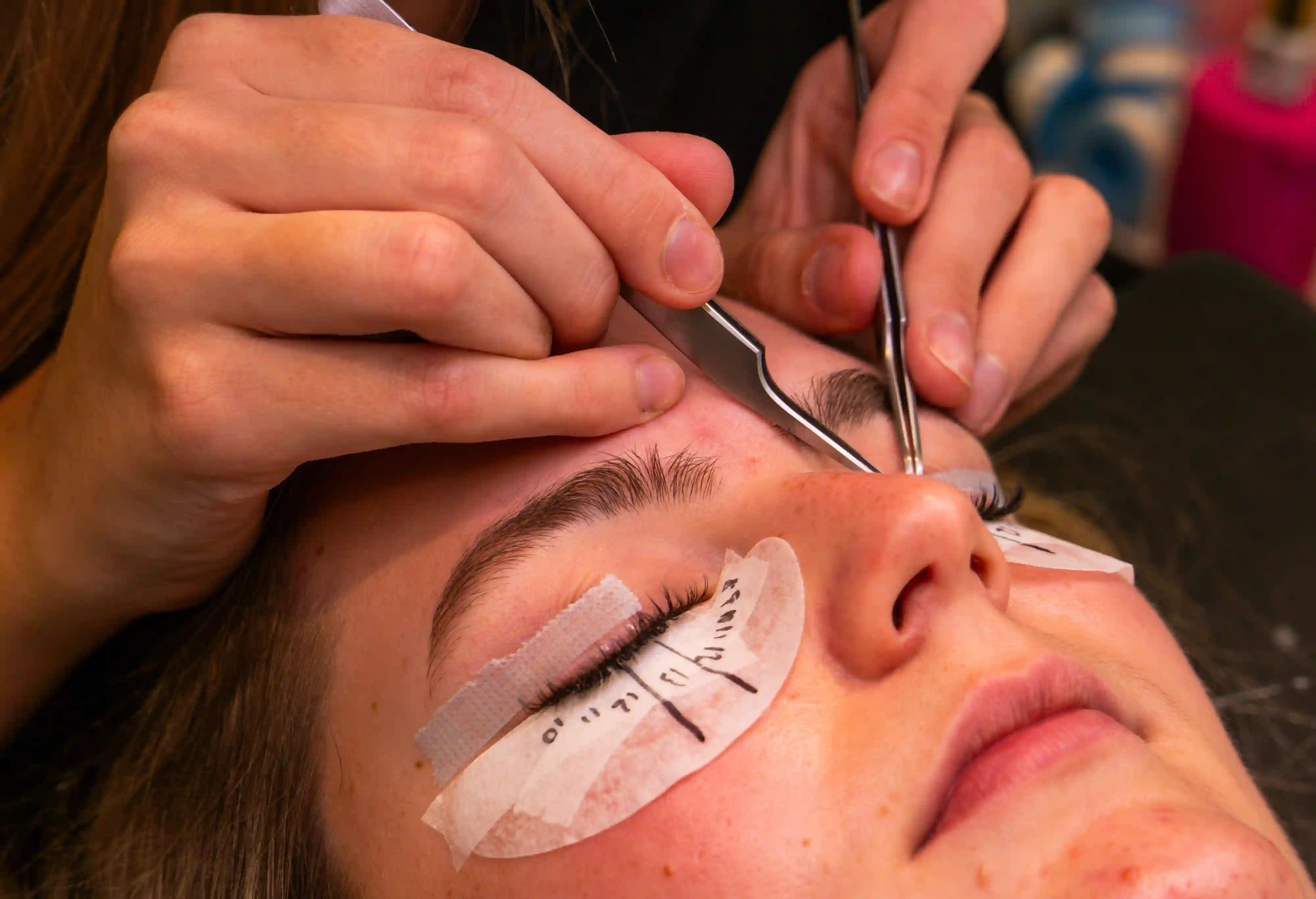 Meena Threading and Waxing Center technician performing eyelash tinting in New York