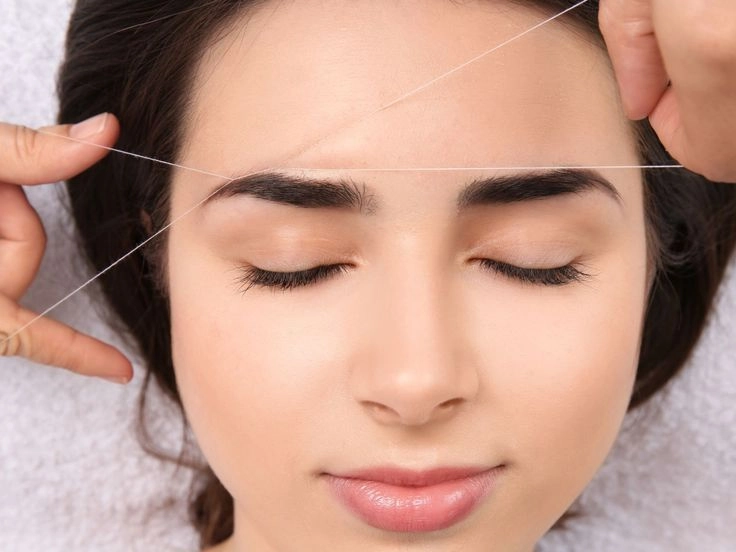 Professional eyebrow threading service performed by a technician at Meena Threading & Waxing Center