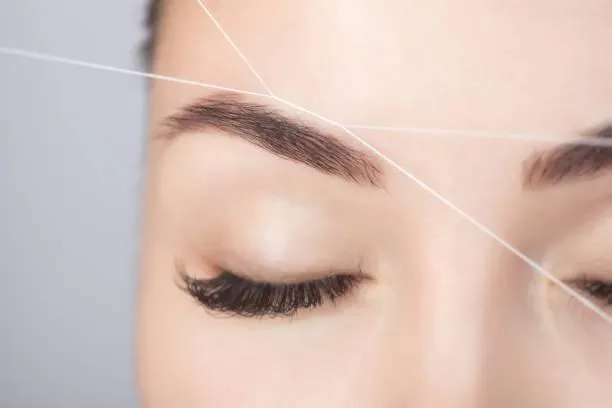 Before and after results of full eyebrow threading treatment
