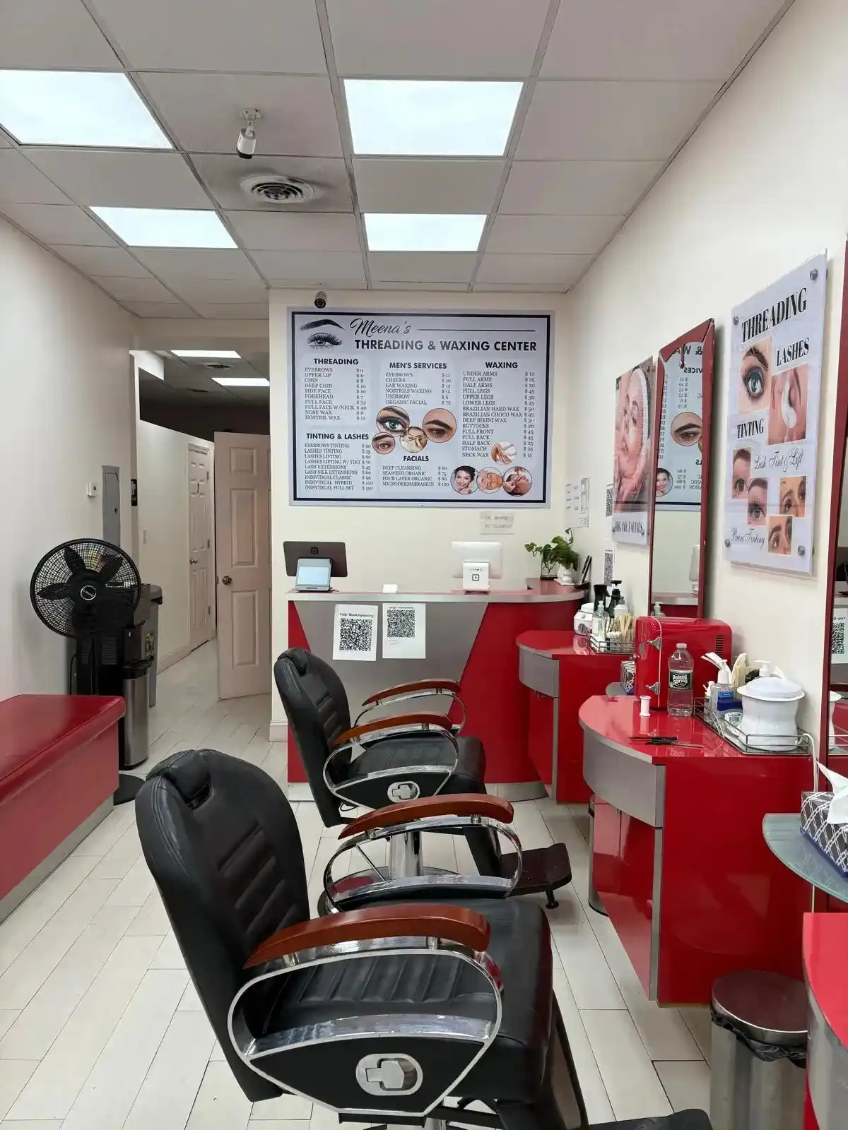 Waxing salon interior with grooming tools and a technician preparing for men's waxing services