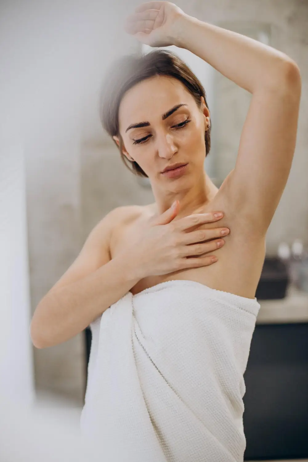 Client enjoying a smooth underarm waxing result at a salon